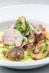 veal roll in bacon with mushroom sauce and potatoes