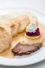 sirloin sauce with dumplings and cranberries on lemon with whipped cream