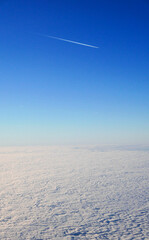 Airplane flying in the blue sky over white clouds  - 495601960
