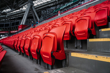 Rows of seats in a football stadium. Bright red stadium seats © Adsloboda