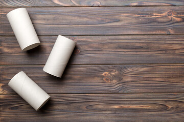 Flat lay composition with empty toilet paper rolls and space for text on color background. Recyclable paper tube with metal plug end made of kraft paper or cardboard