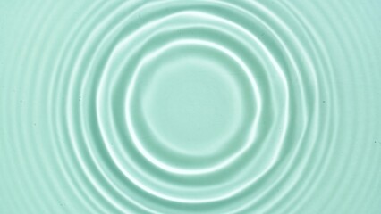 Fototapeta na wymiar Top view of water circles on light green background | Beauty products background