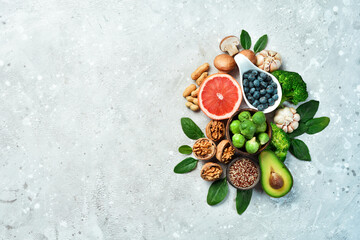 Healthy food background. Concept of Healthy Food, Fresh Vegetables, Nuts and Fruits. On a stone background. Top view. Copy space.