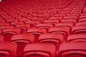 Fototapeta premium Rows of seats in a football stadium. Bright red stadium seats