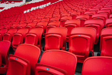 Rows of seats in a football stadium. Bright red stadium seats