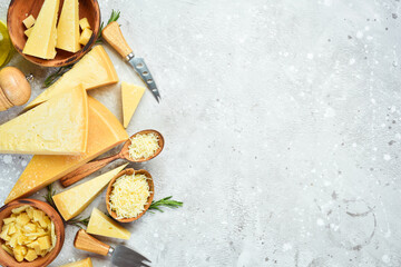 Cheese background. Set of hard cheeses, olives, rosemary and spices. Hard parmesan cheese. Top...