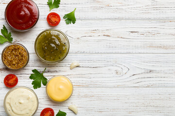 Many different sauces and herbs on table, flat lay top view. sauces with spices healthy concept