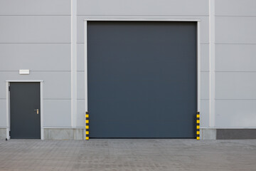 Roller door or roller shutter using for factory, warehouse or hangar. Outdoors.
