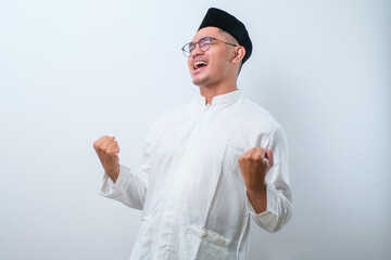 Successful happy muslim man screaming shouting and shows winning victory gesture