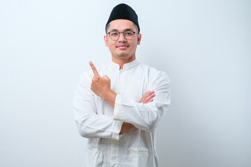 Asian muslim mas pointing something on his side with his both hand