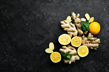 Fresh ginger, mint and lemon on a black background. Top view. On a stone background. - Powered by Adobe