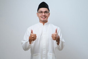 asian muslim male wearing glasses smile look to camera showing thumbs up