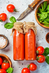 Homemade Tomato Juice in a Glass Bottle. Top view. On a stone background.