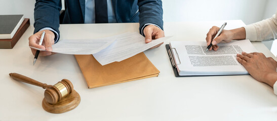 Male lawyer and professional businesswoman working and discussion having at law firm in office,...
