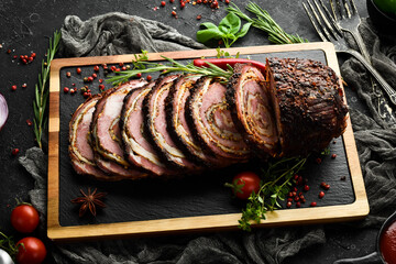 Baked veal and cheese roll with spices and rosemary. Top view. Rustic style.