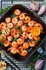 Grilled pan with fried shrimp. Seafood. On a stone background.