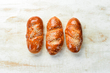 Freshly baked homemade buns with sesame. Baking from rye and flour. Top view. Rustic style.