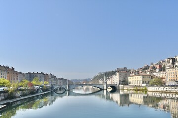 Fototapeta na wymiar Beautiful city of lyon and its bonaparte bridge over the river Sâone on a spring morning