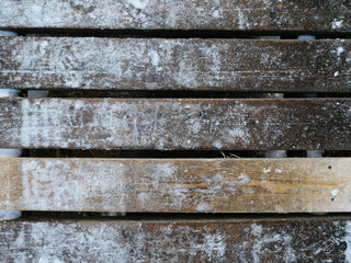 old wooden bridge covered with snow and ice