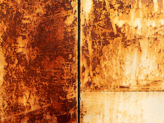 beautiful background of an old solid metal garage wall with corrosion and rust