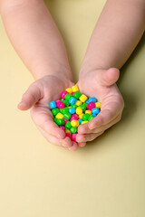 bright colorful sweets in children's palms
