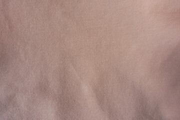 Texture of pale melon pink cotton jersey fabric