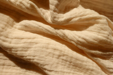Rumpled thin pastel beige cotton muslin fabric - obrazy, fototapety, plakaty