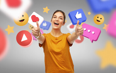 social media, blogging and people concept - happy smiling young woman or teenage girl in orange...