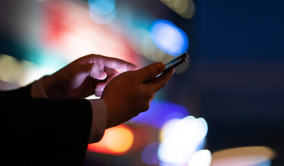Image of a man holding a mobile phone in his hand