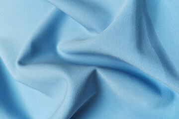 Fototapeta premium Blue crumpled or wavy fabric texture background. Abstract linen cloth soft waves. Silk atlas or stretch jacquard. Smooth elegant luxury cloth texture. Concept for banner or advertisement.