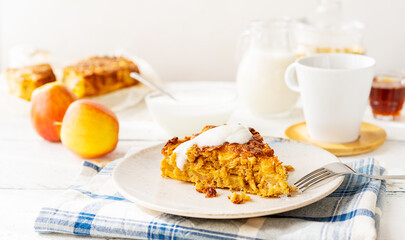 Homemade healthy apple pie with oats, cinnamon and maple syrup as a sweetener, poured with yogurt