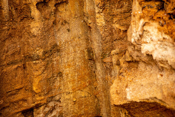 Textural sand, with  relief surface, multi-colored layers and different in size of granules, in outdoor sand career, after mining ore and sand for construction.