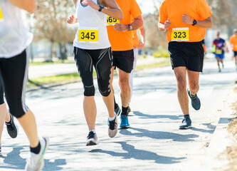 Fototapeta na wymiar Marathon running race, people feet on road.