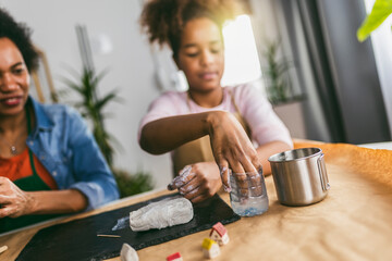 Mother and daughter spend time together and sculpting from clay at home