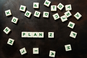 Pieces with letters form the phrase PLAN Z.