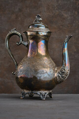 Vintage teapot, sugar on a dark shabby background. Selective focus