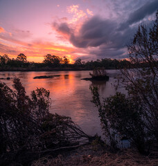 Colourful Riverside Sunset with Cloud Reflections
