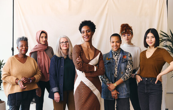 International Women's Day portrait of multiethnic mixed age range women looking confidently towards camera and smiling