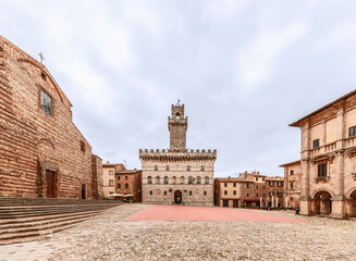 The central square Piazza Grande with Palazzo Comunale (Town Hall) in a Renaissance hill town Montepulciano, Italy