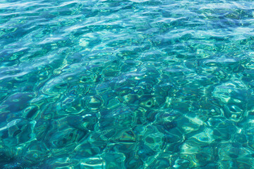 Mens feet in sandals on the beach.