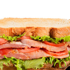 Bacon, lettuce and tomato (BLT) sandwich with double bacon between toasted doorstep bread slices. Close up. Copy space.