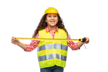 building, construction and profession concept - smiling little girl in protective helmet and safety...