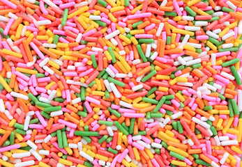 Fototapeta na wymiar a lot of sprinkles as a background. colored sugar sprinkles for food decoration.