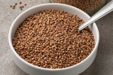 Bowl with traditional raw kasha, roasted buckwheat, close up