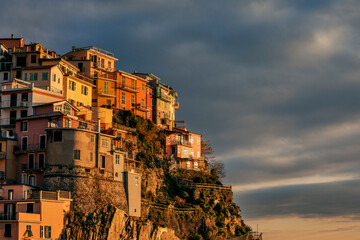 view of the town of manarola by the sea in italy at sunset