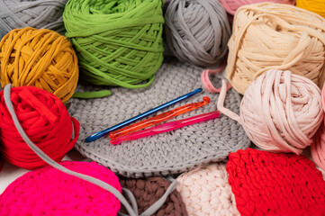 cotton yarn knitting pattern on white table.