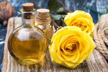 Bubbles with rose oil and rose flowers close-up.
