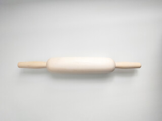 Rolling pin from natural wood on white background. Kitchen utensil. 