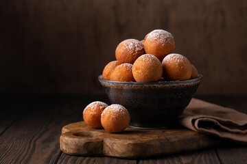 Homemade Donut Holes fried in oil until golden brown and sprinkled with sugar. Castagnole or...