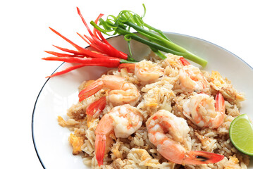 Shrimp fried rice. Stir fried rice with shrimp decorate flowers from red chilly peppers, lime and spring onion on white table.Thai food style. 